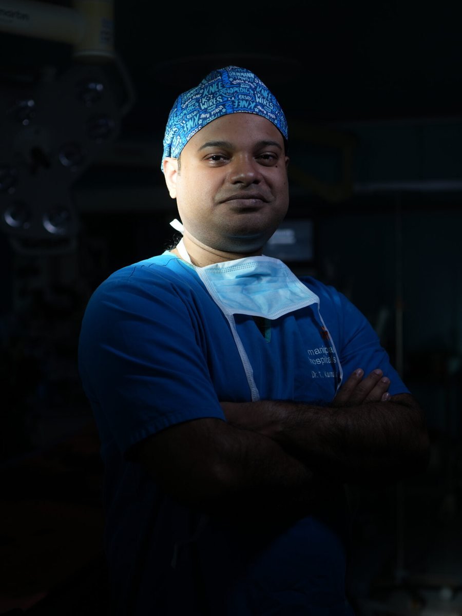 Dr. Tanmoy Karmakar in surgical scrubs in an operating theatre at Manipal Hospitals.