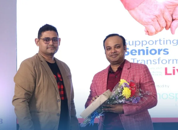 Dr. Tanmoy Karmakar being presented with a bouquet at the event.