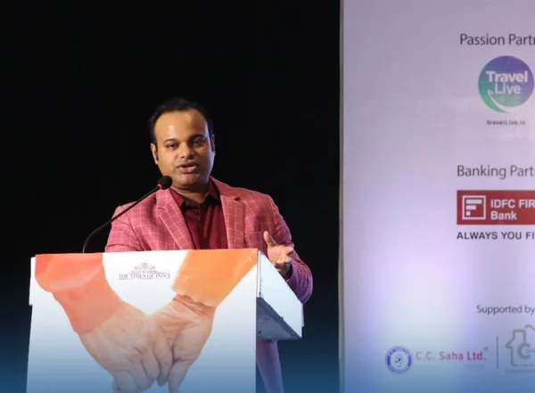 Dr. Tanmoy Karmakar speaking at the Times of India lectern.